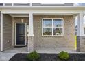 Brick front porch with black door and white columns at 6429 Flag Stop Dr, Whitestown, IN 46075