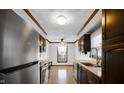 Galley kitchen with dark wood cabinets and quartz countertops at 1053 Millwood Ct # 3, Indianapolis, IN 46260