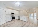 Modern kitchen with white cabinets, stainless steel appliances, and luxury vinyl plank flooring at 2843 Grandview Ln, Greenwood, IN 46143