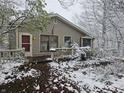 Snow-covered ranch home with a deck and mature landscaping at 15951 E 246Th St, Noblesville, IN 46060