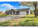 Ranch home with stone accents and a two-car garage at 7234 N Christopher Ln, Fairland, IN 46126