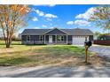 Ranch home with stone accents, two-car garage, and mailbox at 7234 N Christopher Ln, Fairland, IN 46126