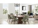 Elegant dining room with a modern wood table and green chairs at 5710 Cloister Ln, McCordsville, IN 46055