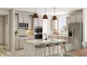 Modern kitchen with light cabinets, double oven, and large island at 5710 Cloister Ln, McCordsville, IN 46055