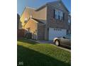 Two-story home with a side view of the garage at 1449 Danielle Dr, Indianapolis, IN 46231