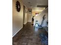Tiled entryway with exercise equipment and view to living room at 1449 Danielle Dr, Indianapolis, IN 46231