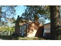 Brick home with side yard and trees at 7716-7718 Michigan Rd, Indianapolis, IN 46268