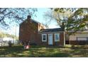 Rear view of brick home with small addition at 7716-7718 Michigan Rd, Indianapolis, IN 46268