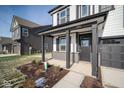 Front entry of a two-story home, featuring a covered porch and brick facade at 1642 Orchard Dr, Fortville, IN 46040