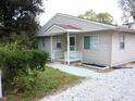 Tan house with white porch and well-maintained landscaping at 309 S Fleming St, Indianapolis, IN 46241