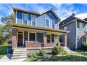 Blue and yellow two-story house with a brick porch at 1007 Broadway St, Indianapolis, IN 46202