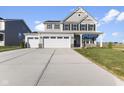 Move-in ready two-story home with a three-car garage and landscaped lawn at 230 Mcnair Rd, Whiteland, IN 46184