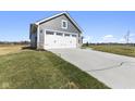 Two car garage with white doors and gray siding on a craftsman style home at 432 Charles Freer Ln, Whiteland, IN 46184