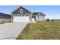 White two-car garage and gray siding highlight this newly built home's exterior at 432 Charles Freer Ln, Whiteland, IN 46184