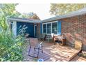 Brick home with wooden deck, chairs, and landscaping at 7060 S Meridian St, Indianapolis, IN 46217