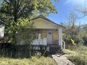 Yellow bungalow with front porch and walkway at 3221 E 38Th St, Indianapolis, IN 46218
