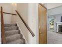 Indoor stairs with carpeted steps and wooden handrail at 4239 Larkspur Trce, Indianapolis, IN 46237