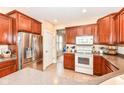 Spacious kitchen with stainless steel appliances and wood cabinets at 5202 Hearst Ln, Indianapolis, IN 46239