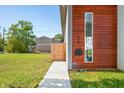 Modern home exterior with wood siding and landscaped lawn at 318 N Tacoma Ave, Indianapolis, IN 46201