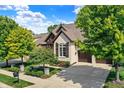 Beautiful home exterior with landscaping and driveway at 15571 Bridgewater Club Blvd, Carmel, IN 46033