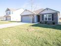 Two-story home with gray garage door and spacious lawn at 6105 Card Blvd, Indianapolis, IN 46221
