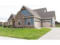 Side view of home showcasing garage at 4407 W Wandalee Ct, New Palestine, IN 46163