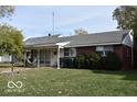 Brick ranch house with a landscaped yard at 2112 N Ball Ave, Muncie, IN 47304