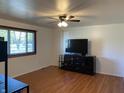 Living room with hardwood floors and a large TV at 647 W Mcgregor Rd, Indianapolis, IN 46217