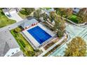 Community pool with a blue cover and surrounding residential area at 7178 Lockford N, Avon, IN 46123