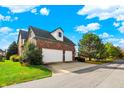 Two-car attached brick garage with white doors at 7178 Lockford N, Avon, IN 46123