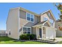 Two-story house with beige siding, white garage door, and landscaping at 4633 Angelica Dr, Indianapolis, IN 46237