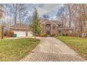 Two-story brick home with a driveway and basketball hoop at 808 Copperfield Xing, Danville, IN 46122