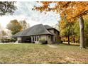 Back of house with patio and fall leaves at 9230 Nw Oak St, Alexandria, IN 46001