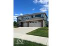 Two-story home with three-car garage and brick facade at 3609 Merchmont Rd, Bargersville, IN 46106