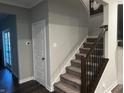 Modern staircase with dark wood railings and grey carpet at 3609 Merchmont Rd, Bargersville, IN 46106
