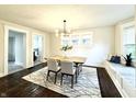 Bright dining room with wood floors and modern chandelier at 2641 Guilford Ave, Indianapolis, IN 46205