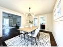 Bright dining room with wood floors and modern chandelier at 2641 Guilford Ave, Indianapolis, IN 46205