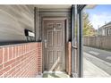 Private entrance with a brown door and brick accents at 1521 N Alabama St # L, Indianapolis, IN 46202