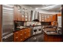 Modern kitchen with curved cabinetry, stainless steel appliances, and granite countertops at 9468 Sullivan Pl, Zionsville, IN 46077