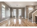 Spacious living room with hardwood floors and large windows at 711 N Cleveland St, Indianapolis, IN 46202