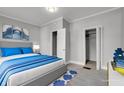 Virtually staged bedroom with gray walls and blue bedding at 1253 Eugene St, Indianapolis, IN 46208