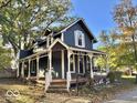 Two-story home with a wraparound porch and mature trees at 74 Morgan St, Danville, IN 46122