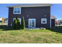 House back with patio and evergreen trees at 428 N Wyndstone Way, Fortville, IN 46040