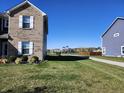 Side yard view with playground in the distance at 428 N Wyndstone Way, Fortville, IN 46040