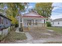 Charming craftsman style home with red metal roof and front porch at 1208 W 18Th St, Indianapolis, IN 46202
