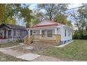 Charming craftsman style home with red metal roof and front porch at 1208 W 18Th St, Indianapolis, IN 46202