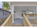 Front porch with wood railings and gray decking at 1208 W 18Th St, Indianapolis, IN 46202