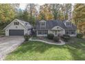 Aerial view of a house with a two-car garage and landscaped yard at 6971 Lynx Dr, Nineveh, IN 46164