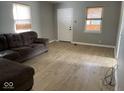 Bright living room featuring light gray walls and wood-look flooring at 6150 Oak Ave, Indianapolis, IN 46219