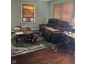 Living room with leather furniture and hardwood floors at 4529 Crittenden Ave, Indianapolis, IN 46205